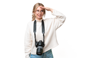 Young photographer English woman over isolated background looking far away with hand to look something