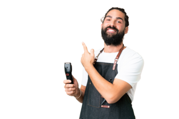 Young barber man over isolated chroma key background pointing back