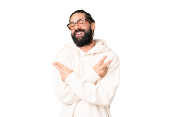 Young man with beard over isolated chroma key background smiling and showing victory sign