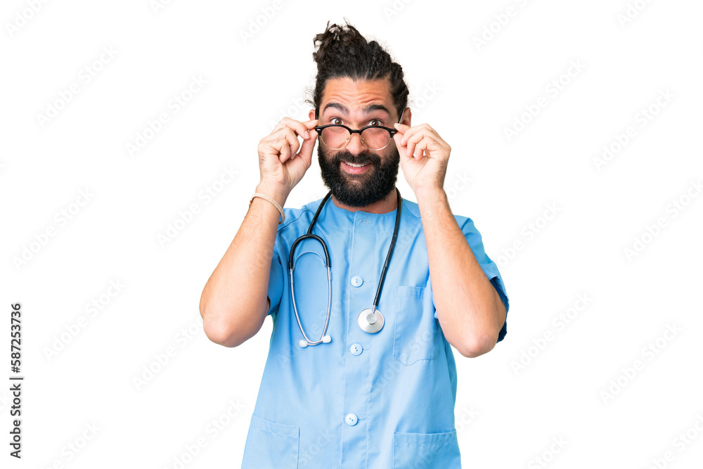 Wall mural young doctor man over isolated chroma key background with glasses and surprised