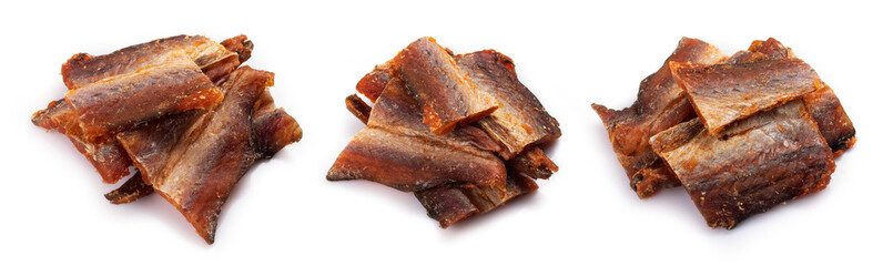 Pieces of cleaned dried fish isolated on white. Dry Peppered Pollack. Amber with pepper Collection