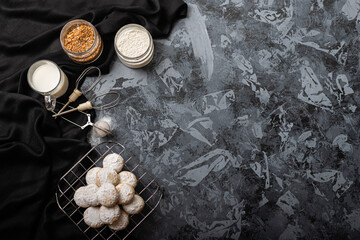 Traditional arabian cookies (kahk) sprinkled with white sugar and it's ingredients (flour, milk, butter, sugar and nuts)
