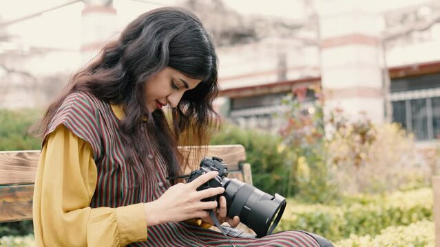 Young middle eastern woman using DSLR camera
