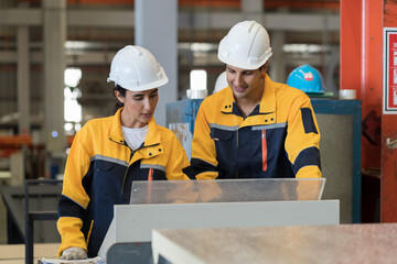 Manufacturing industrial concept. Male and female engineer workers checking, repair and maintenance conveyor belt machine at manufacturing production lines in factory during manufacturing process
