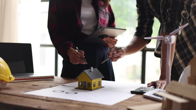 carpenter at work with home model.