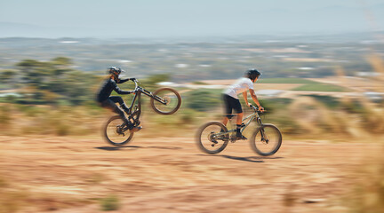 Mountain bike, men and race with speed, dirt and nature in summer with wheelie, extreme sport and...