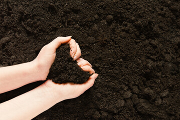 Symbol earth day. Handful of earth in hand. Farmer hands soil ground earth dirt garden soil farm ground. Fertile land field agriculture concept	