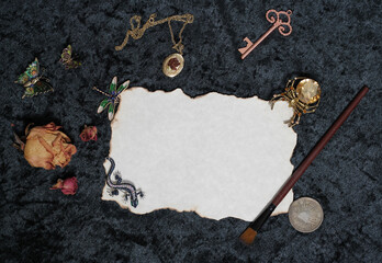 Paint Brush on Old Paper With Dried Flowers and Locket