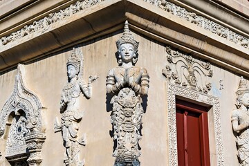 Fototapeta na wymiar Thai white angel statue stucco in Wat Phra Singh , temple in Chiang Mai, Thailand.