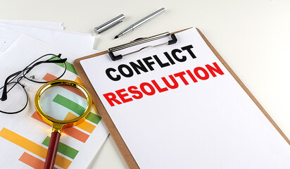 CONFLICT RESOLUTION text on clipboard with chart on white background, business concept