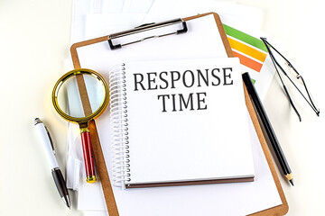 RESPONSE TIME text on notebook with clipboard on white background