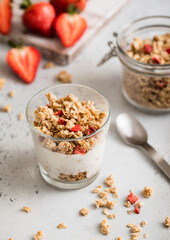 Fototapeta na wymiar Natural yogurt with strawberry granola and fresh berries