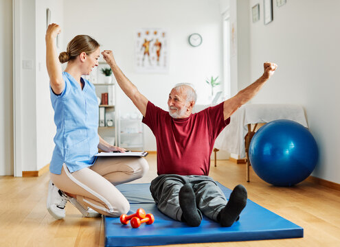 nurse doctor senior care exercise physical therapy exercising help assistence happy strong physiotherapy strech band clinic therapist elderly man