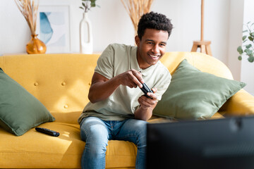 Cheerful black man playing videogames