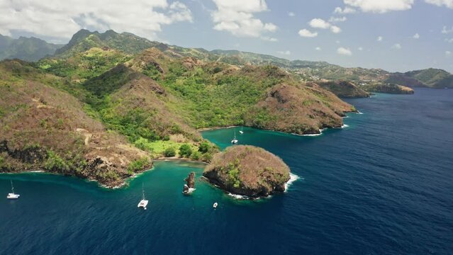 Lost island in caribbean sea surrounded by palm trees, blue water and coral reef.