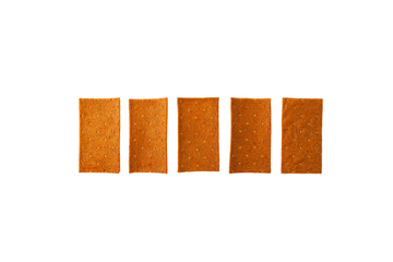 Crisps with paprika in row on white background, top view. Design element, copy space. Crispy rye bread. Dehydrated food. Wholegrain crispbread, rye crisp