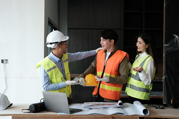 Team of engineers working on a personal computer at a metallurgical workshop.