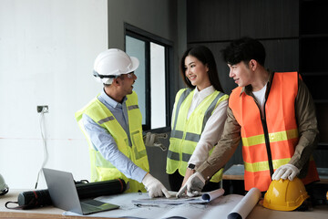 Team of engineers working on a personal computer at a metallurgical workshop.