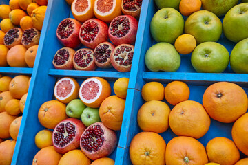 Oranges, pomegranates, apples, grapefruits. Fresh fruits background