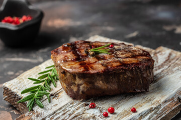 grilled beef steaks with spices on a wooden board. Restaurant menu, dieting, cookbook recipe top view