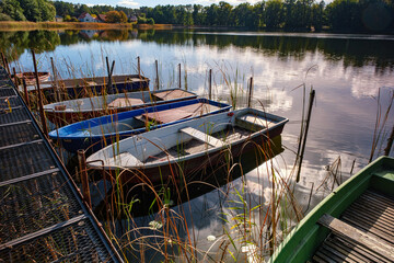 Small fishing boats anchored on the shore of the lake. Fishing harbor.