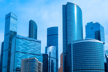 Moscow-city. Cities of Russia. Bottom view of skyscrapers in center of Russian capital. Business center of Moscow. Office rental in Moscow. Office real estate. High-rise buildings against blue sky