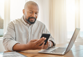 Phone, laptop and remote work with a black man checking his debt or banking from the home office. Pension, contact and communication with senior male working on finance in a living room of his house