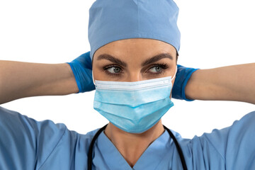 Mid section of health worker wearing gloves, mask and stetoscope against black background