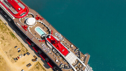 Aerial view of a large cruise ship docked at the port. There is no one on board and the ship is...