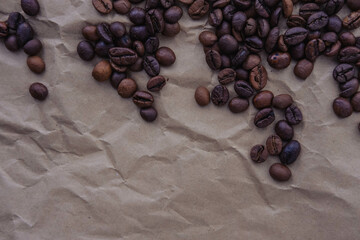 Coffee beans on brown paper background, can be used as a background