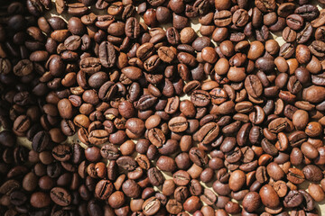 Coffee beans on brown paper background, can be used as a background