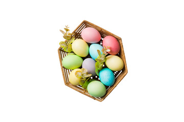 Basket of colorful Easter eggs isolated on white background. Easter basket filled with colored eggs top view holiday concept