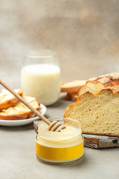 homemade bread, honey with milk for breakfast. vertical image. top view. place for text