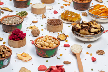 Healthy vegetarian food concept. Assortment of dried fruits, nuts and seeds on white background. Top view. Mixed nuts set closeup.
