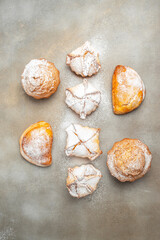 muffins and cupcakes sprinkled with powdered sugar, vertical image. top view. place for text