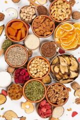 
Healthy vegetarian food concept. Assortment of dried fruits, nuts and seeds on white background. Top view.
