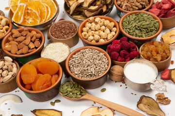 Healthy vegetarian food concept. Assortment of dried fruits, nuts and seeds on white background. Top view.