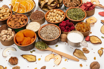 Healthy vegetarian food concept. Assortment of dried fruits, nuts and seeds on white background. Top view. Mixed nuts set closeup.