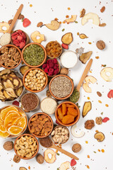 Healthy vegetarian food concept. Assortment of dried fruits, nuts and seeds on white background. Top view.