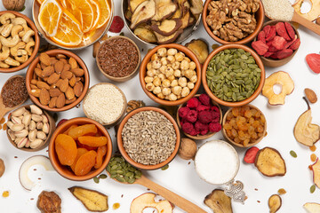 Healthy vegetarian food concept. Assortment of dried fruits, nuts and seeds on white background. Top view. Mixed nuts set closeup.
