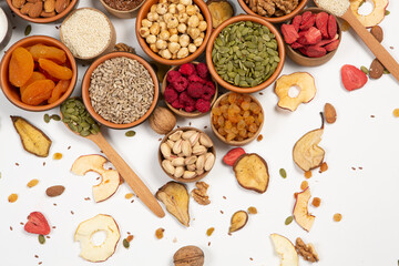 Healthy vegetarian food concept. Assortment of dried fruits, nuts and seeds on white background. Top view.