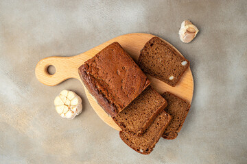 whole grain garlic bread on wooden board, banner, menu, recipe place for text, top view