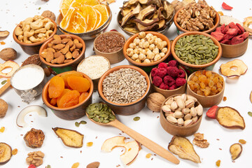 Healthy vegetarian food concept. Assortment of dried fruits, nuts and seeds on white background. Top view. Mixed nuts set closeup.