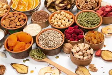 Healthy vegetarian food concept. Assortment of dried fruits, nuts and seeds on white background. Top view. Mixed nuts set closeup.