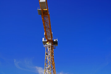 Lattice boom crane in use on a large construction site