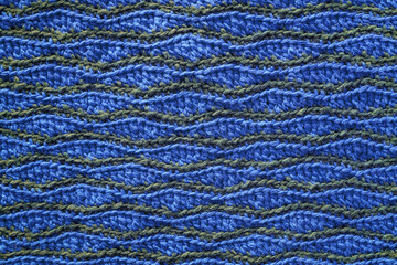 Blue grey crocheted wave pattern. Knitted texture.