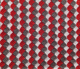 Red white grey knitted background. Crochet tunisain entrelac.
