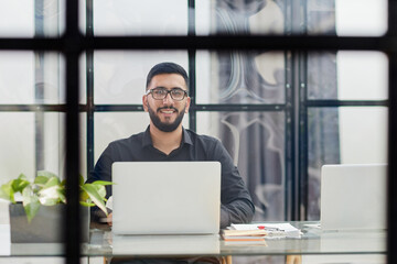 Middle-aged man working on laptop in office