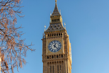 Close up of Big Ben against a blue sky in warm sunshine