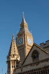 Fototapeta na wymiar Close up of Big Ben against a blue sky in warm sunshine